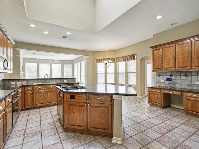 800 Rock Hill Rd, Prosper, TX 75078 - kitchen with healthy amount of natural light, brown cabinetry, recessed lighting, and backsplash