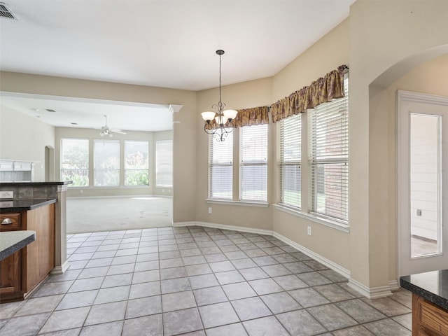 800 Rock Hill Rd, Prosper, TX 75078 - unfurnished dining area with light tile patterned floors, ceiling fan, arched walkways, and a chandelier