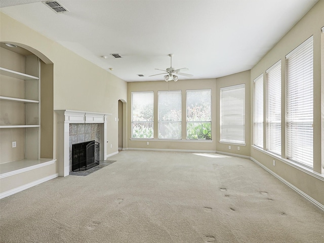 800 Rock Hill Rd, Prosper, TX 75078 - unfurnished living room featuring a ceiling fan, healthy amount of natural light, carpet, and a tiled fireplace