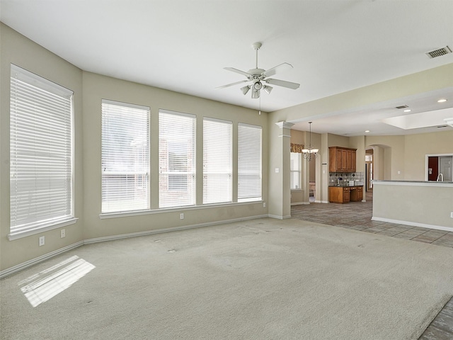 800 Rock Hill Rd, Prosper, TX 75078 - unfurnished living room featuring a ceiling fan, light carpet, arched walkways, and a chandelier
