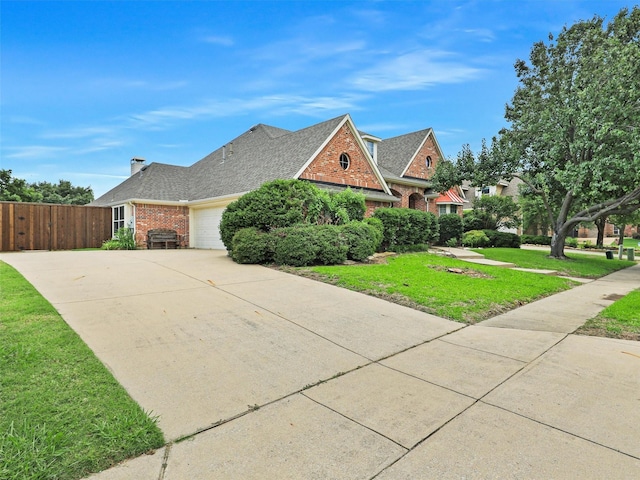 800 Rock Hill Rd, Prosper, TX 75078 - view of front facade featuring brick siding, an attached garage, driveway, and roof with shingles