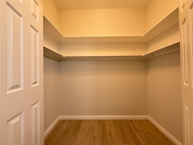8525 Clearcreek Cir, Frisco, TX 75034 - walk in closet with wood finished floors