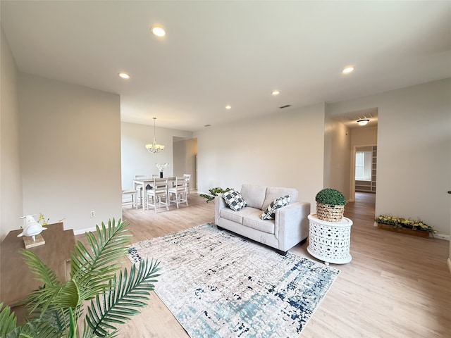 8525 Clearcreek Cir, Frisco, TX 75034 - living area with light wood-style floors, recessed lighting, and a chandelier