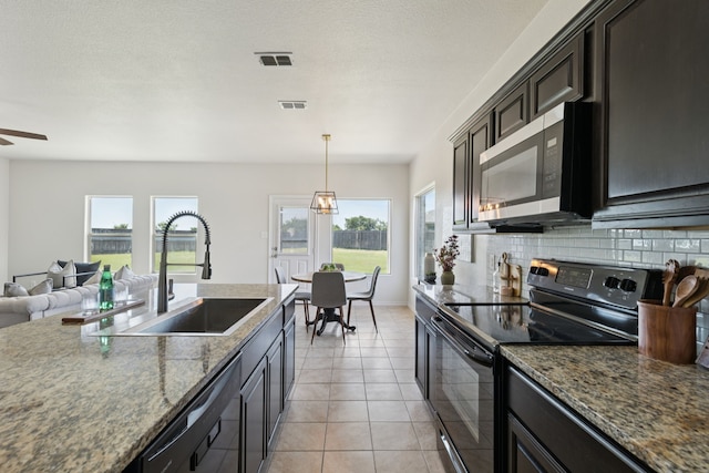 313 Pimlico Way, Ponder, TX 76259 - kitchen with black appliances, tasteful backsplash, a ceiling fan, open floor plan, and light tile patterned floors