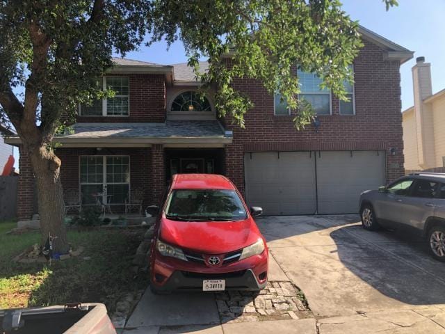 2542 Dove Crossing Dr, New Braunfels, TX 78130 - view of front facade featuring a garage, brick siding, and driveway