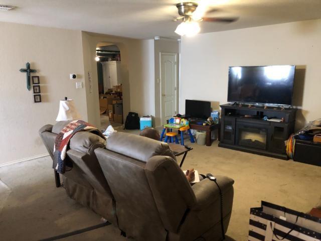 2542 Dove Crossing Dr, New Braunfels, TX 78130 - carpeted living room with arched walkways and ceiling fan