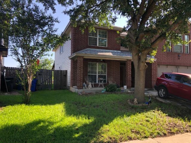 2542 Dove Crossing Dr, New Braunfels, TX 78130 - traditional-style home with brick siding, an attached garage, a porch, and driveway