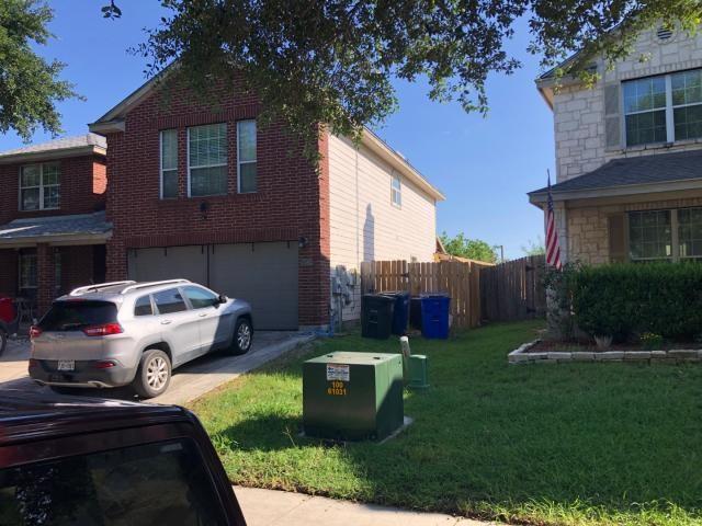 2542 Dove Crossing Dr, New Braunfels, TX 78130 - view of side of property with an attached garage, driveway, and brick siding