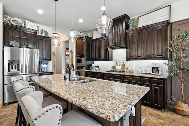 6513 Deer Horn Dr, Fort Worth, TX 76179 - kitchen featuring stainless steel appliances, decorative backsplash, light stone countertops, a breakfast bar area, and an island with sink