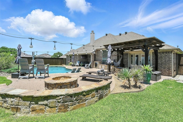 6513 Deer Horn Dr, Fort Worth, TX 76179 - rear view of house with a fire pit, brick siding, a fenced backyard, and a patio area