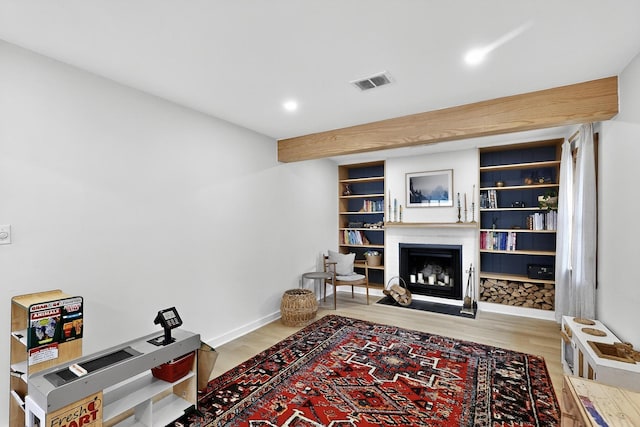 3733 Tam O Shanter Dr, Mesquite, TX 75150 - living room featuring a fireplace with flush hearth, wood finished floors, and recessed lighting