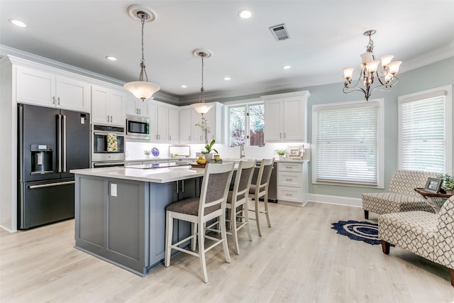 3816 Shady Meadow Dr, Grapevine, TX 76051 - kitchen with appliances with stainless steel finishes, white cabinetry, ornamental molding, a center island, and a chandelier