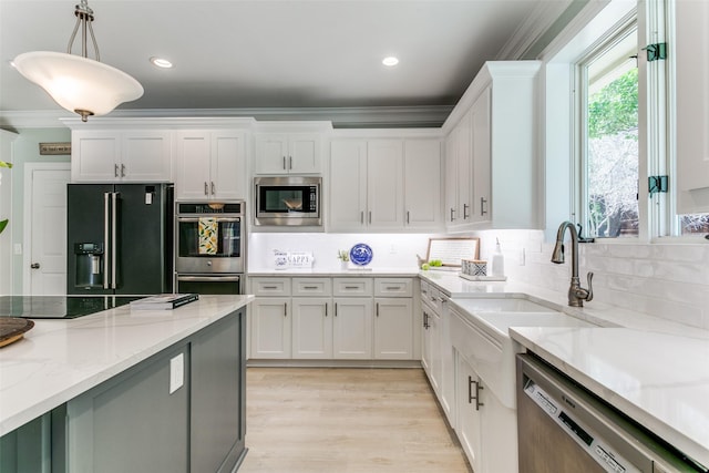 3816 Shady Meadow Dr, Grapevine, TX 76051 - kitchen featuring stainless steel appliances, white cabinetry, tasteful backsplash, ornamental molding, and decorative light fixtures