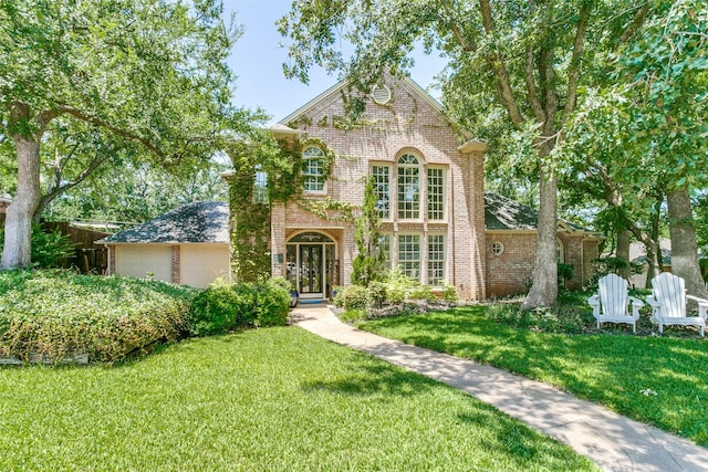 3816 Shady Meadow Dr, Grapevine, TX 76051 - view of front of property featuring brick siding, a front yard, french doors, and an attached garage