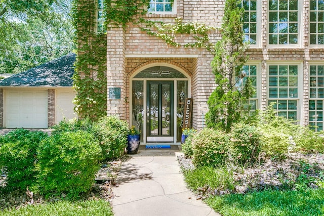 3816 Shady Meadow Dr, Grapevine, TX 76051 - view of exterior entry featuring brick siding, french doors, and a garage