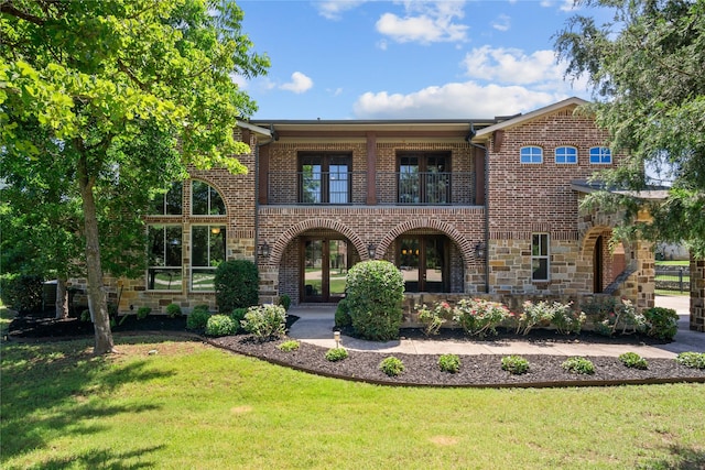 6901 Hickory Hill Cir, Argyle, TX 76226 - view of front of home featuring a balcony, brick siding, and a front lawn