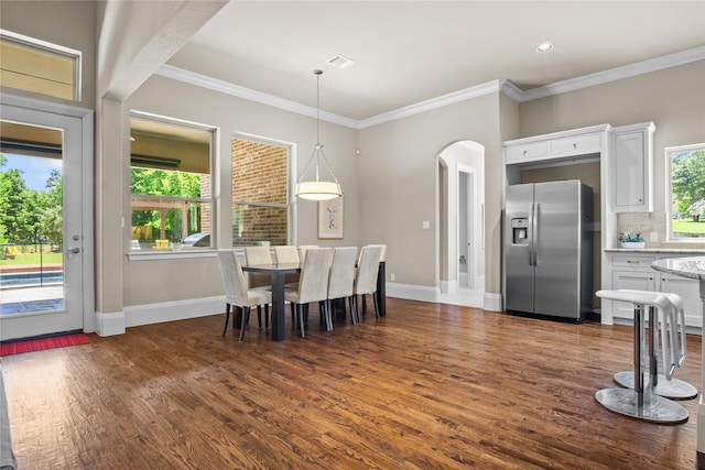 6901 Hickory Hill Cir, Argyle, TX 76226 - dining area with arched walkways, dark wood-style floors, and crown molding