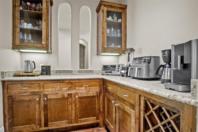 6901 Hickory Hill Cir, Argyle, TX 76226 - kitchen featuring brown cabinets, glass insert cabinets, and light stone counters