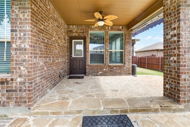 601 Redding Dr, Saginaw, TX 76131 - doorway to property with ceiling fan, brick siding, and a patio area