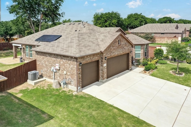601 Redding Dr, Saginaw, TX 76131 - view of front of home with roof with shingles, brick siding, an attached garage, solar panels, and concrete driveway