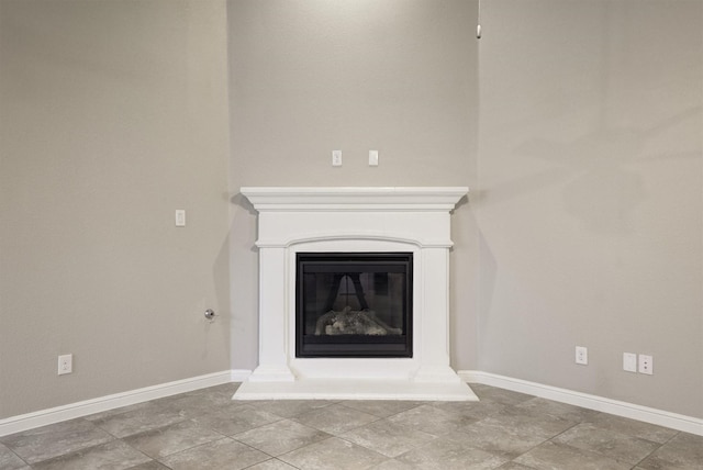 601 Redding Dr, Saginaw, TX 76131 - detailed view of baseboards and a glass covered fireplace
