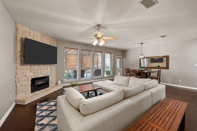 3413 Westfork Ranch Rd, Fort Worth, TX 76262 - living area featuring a ceiling fan, a stone fireplace, and dark wood-type flooring