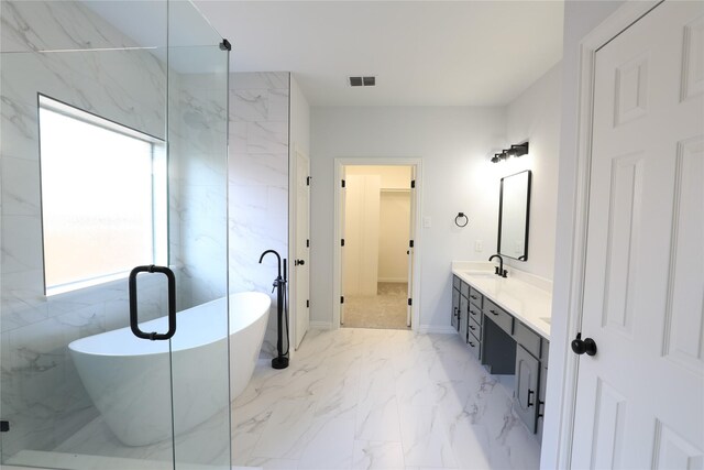 3620 Flintstone Dr, Plano, TX 75074 - full bath with marble finish flooring, double vanity, a walk in closet, and a freestanding tub