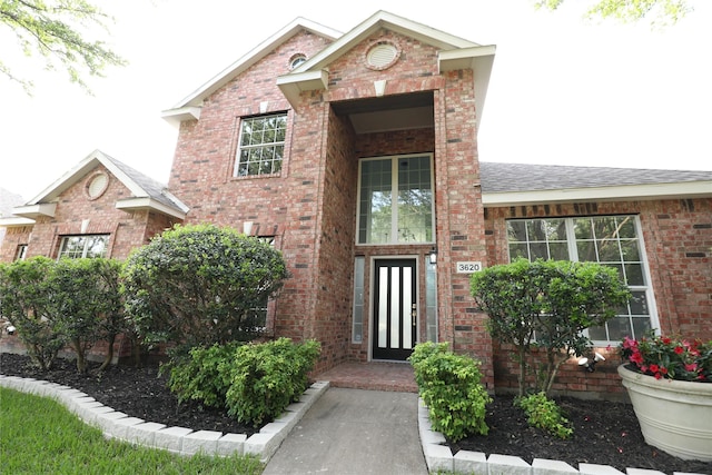 3620 Flintstone Dr, Plano, TX 75074 - doorway to property featuring brick siding and a shingled roof