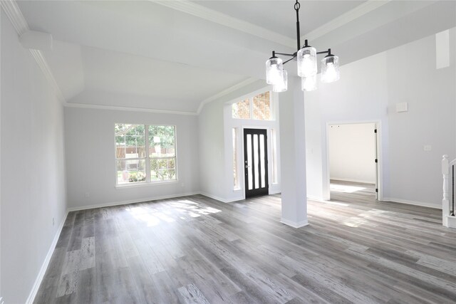 3620 Flintstone Dr, Plano, TX 75074 - unfurnished living room featuring a chandelier, crown molding, wood finished floors, and lofted ceiling