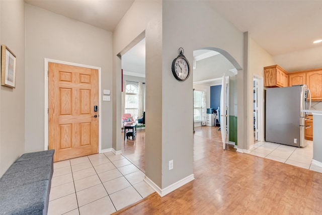 1306 Glendover Dr, Allen, TX 75013 - foyer entrance with arched walkways, lofted ceiling, and light tile patterned flooring