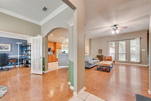 1306 Glendover Dr, Allen, TX 75013 - living area featuring ceiling fan, arched walkways, ornamental molding, light wood-style flooring, and an office area