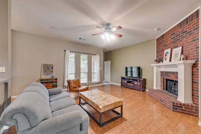 1306 Glendover Dr, Allen, TX 75013 - living area with light wood-type flooring, ceiling fan, a brick fireplace, and brick wall