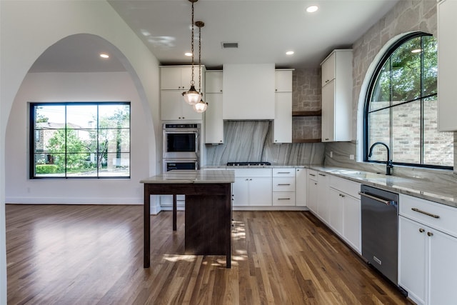 9701 Faircrest Dr, Dallas, TX 75238 - kitchen featuring stainless steel appliances, dark wood finished floors, light stone countertops, white cabinetry, and backsplash