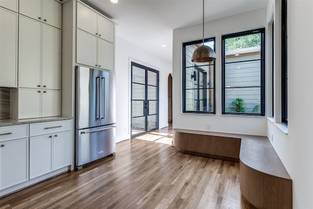 9701 Faircrest Dr, Dallas, TX 75238 - kitchen featuring high end refrigerator, light wood-style flooring, arched walkways, light countertops, and recessed lighting