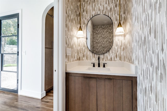 9701 Faircrest Dr, Dallas, TX 75238 - bathroom featuring vanity, wallpapered walls, and wood finished floors
