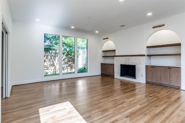 9701 Faircrest Dr, Dallas, TX 75238 - unfurnished living room with light wood finished floors, recessed lighting, and a fireplace