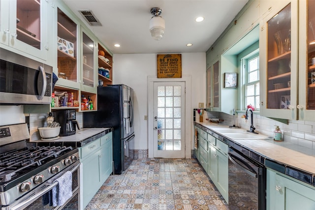 1320 Madeline Pl, Fort Worth, TX 76107 - kitchen featuring appliances with stainless steel finishes, tasteful backsplash, recessed lighting, healthy amount of natural light, and green cabinetry