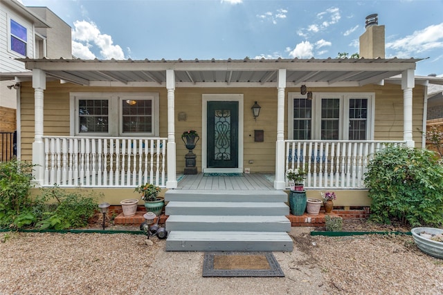 1320 Madeline Pl, Fort Worth, TX 76107 - doorway to property featuring a porch, a chimney, and a metal roof