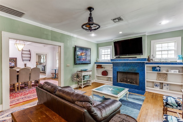 1320 Madeline Pl, Fort Worth, TX 76107 - living area featuring ornamental molding, wood finished floors, a fireplace with flush hearth, and recessed lighting
