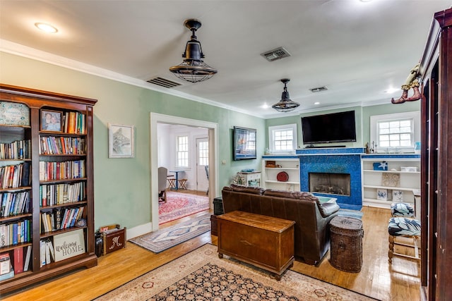 1320 Madeline Pl, Fort Worth, TX 76107 - living area featuring wood finished floors, ornamental molding, healthy amount of natural light, a fireplace, and recessed lighting