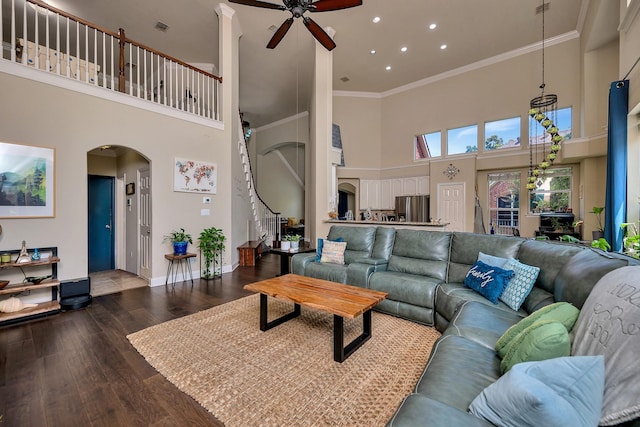 700 Paradise Cv, Shady Shores, TX 76208 - living area featuring a towering ceiling, arched walkways, ceiling fan, dark wood finished floors, and stairway