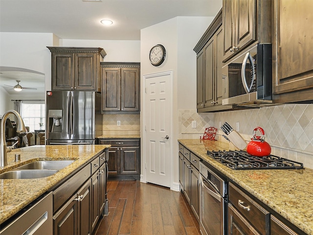 505 Peterhouse Dr, Mckinney, TX 75071 - kitchen featuring stainless steel appliances, ceiling fan, dark brown cabinetry, and dark wood-style floors