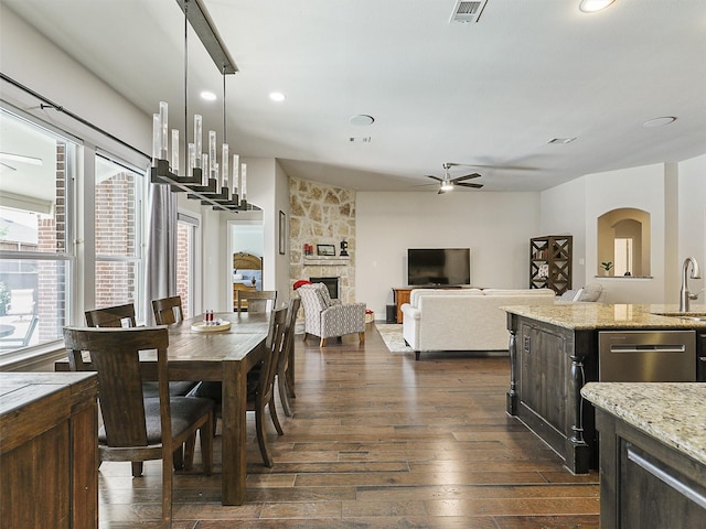 505 Peterhouse Dr, Mckinney, TX 75071 - dining area featuring healthy amount of natural light, ceiling fan, dark wood-type flooring, a fireplace, and recessed lighting
