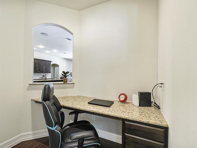 505 Peterhouse Dr, Mckinney, TX 75071 - office featuring arched walkways, dark wood finished floors, and built in desk