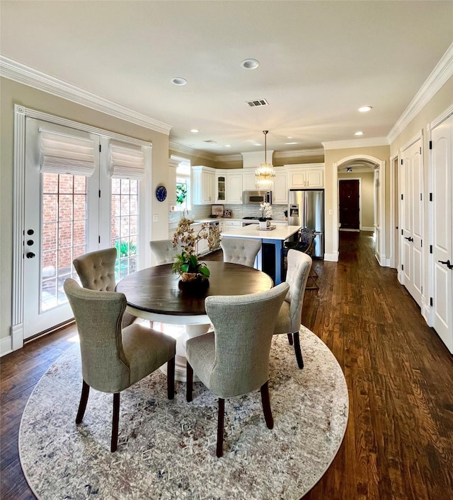 4716 Eva Pl, Plano, TX 75093 - dining area with ornamental molding, arched walkways, dark wood-style flooring, and recessed lighting