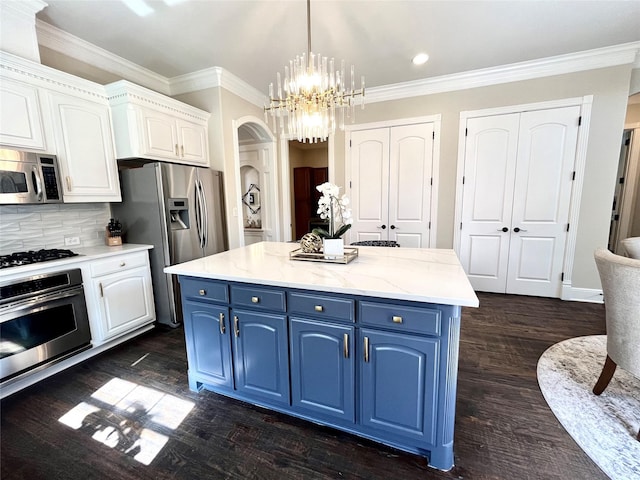 4716 Eva Pl, Plano, TX 75093 - kitchen with blue cabinetry, stainless steel appliances, arched walkways, white cabinetry, and decorative backsplash