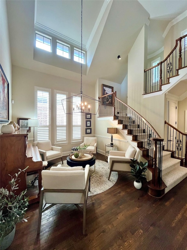 4716 Eva Pl, Plano, TX 75093 - living area with a high ceiling, wood finished floors, stairway, ornamental molding, and a chandelier