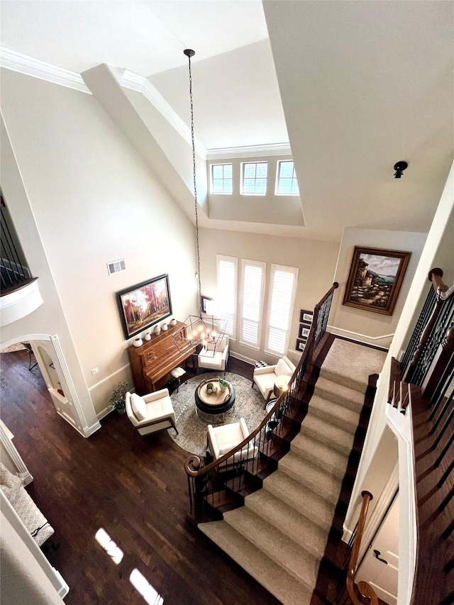 4716 Eva Pl, Plano, TX 75093 - living room with crown molding, stairs, wood finished floors, and a high ceiling