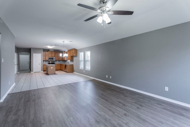 3106 Connor Ln, Wylie, TX 75098 - unfurnished living room featuring ceiling fan and light wood finished floors