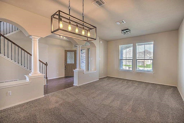 9207 Lake Pointe Dr, Temple, TX 76502 - foyer entrance with decorative columns, dark colored carpet, stairway, and arched walkways